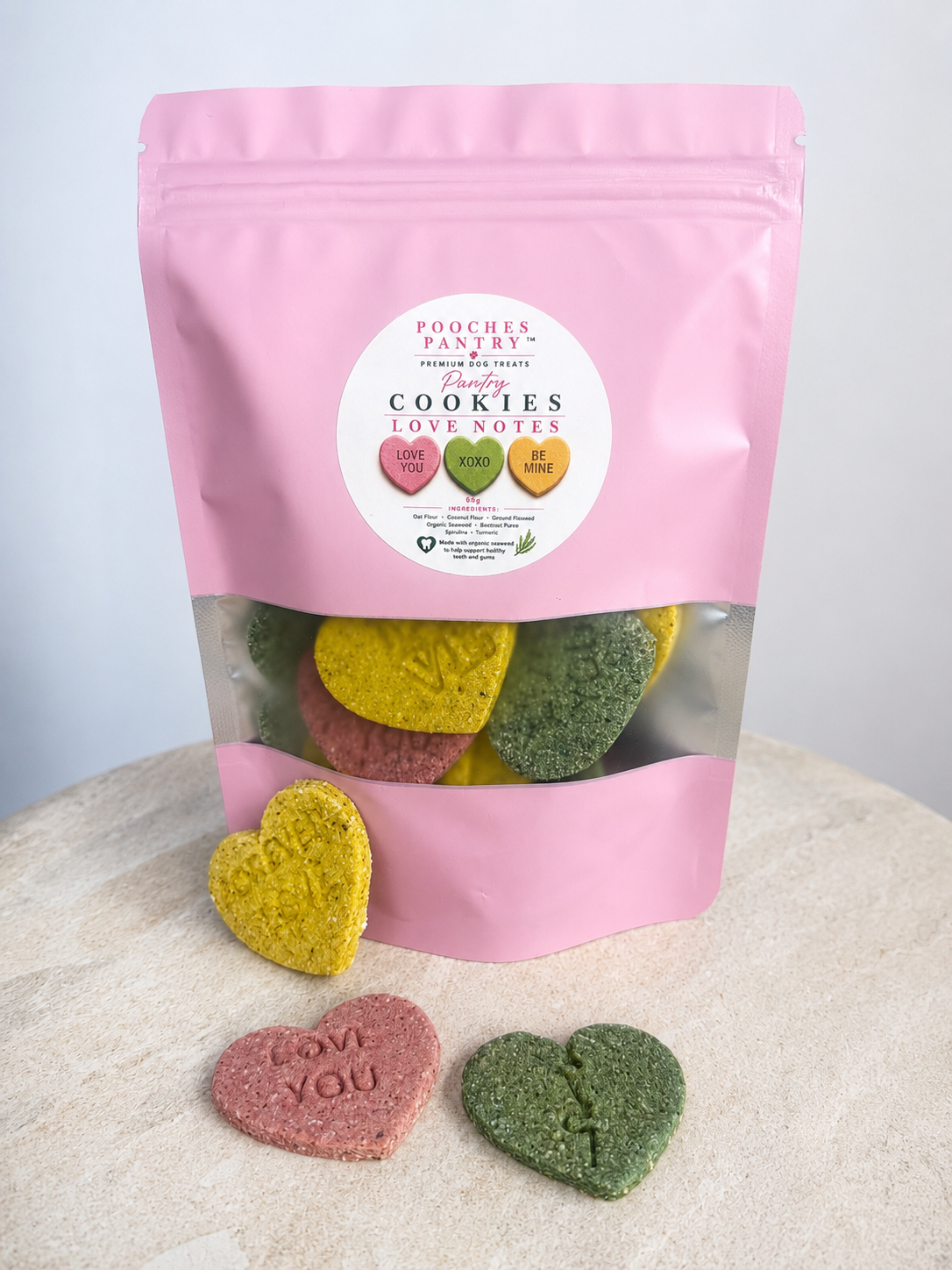 Love Notes dog cookies — colourful message-heart cookies in a pink Pooches Pantry bag