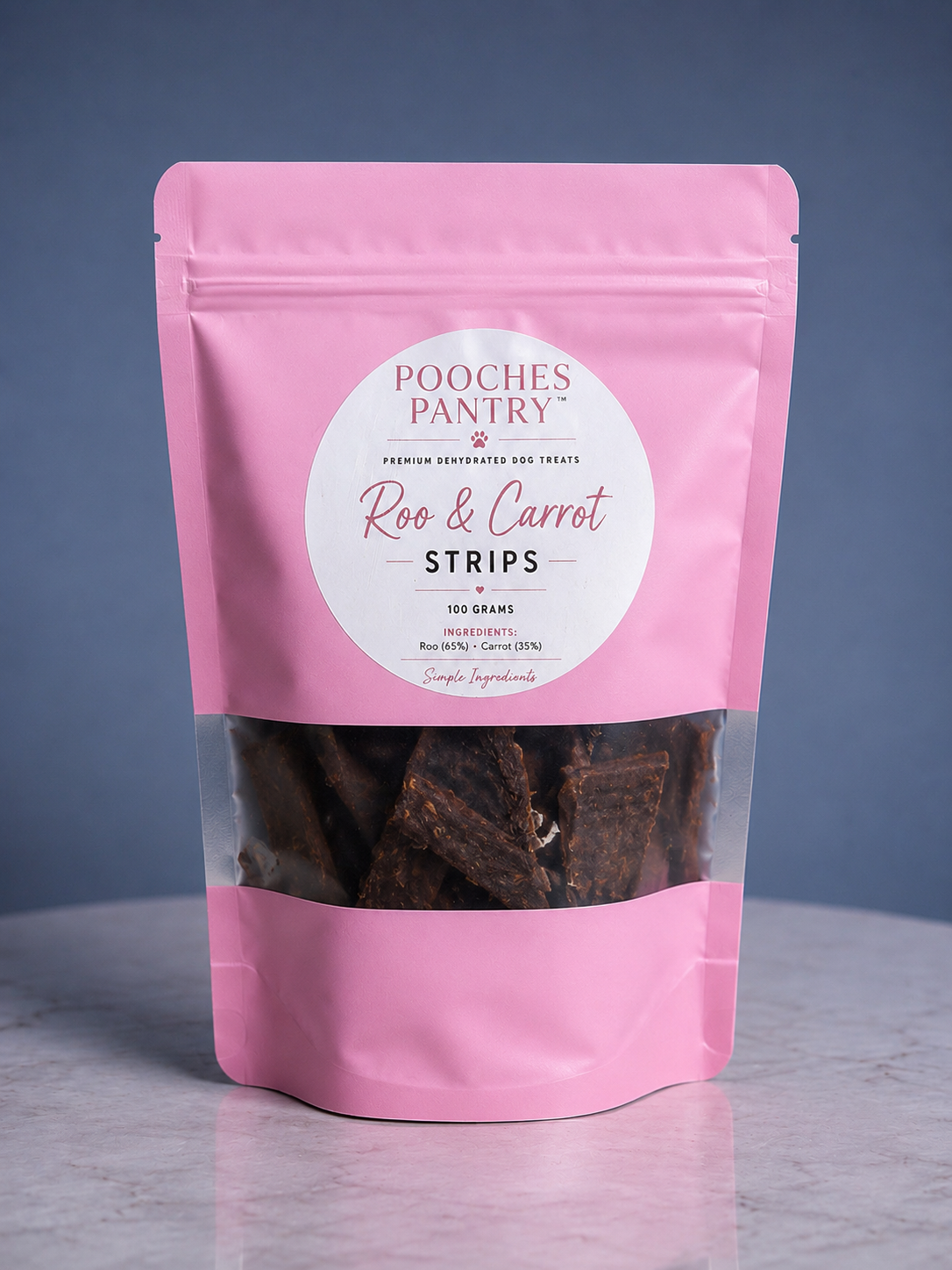 Roo & Carrot Strips dog treats in a pink Pooches Pantry pouch
